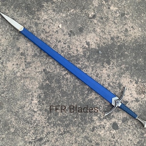 May include: A longsword with a blue leather-wrapped scabbard and hilt, featuring a silver-toned metal pommel, crossguard, and chape. The text FFR Blades is visible near the crossguard on the blue scabbard of this sword.