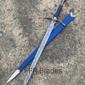May include: A sword with a patterned Damascus steel blade, a blue wrapped handle, and a silver pommel. The crossguard features a small blue stone. It is accompanied by a blue scabbard with silver accents. The text FFR Blades is visible.