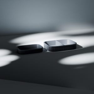May include: Two rectangular containers with dark grey ribbed exterior walls and light grey interiors. The smaller container is a single open basin, while the larger container features a central divider, creating two distinct compartments.