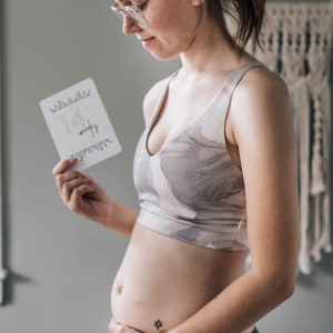 "14 Weeks" Minimalist Pregnancy Milestone Card being held by pregnant woman next to her growing belly -  by Nuts & Bolts Paper Co