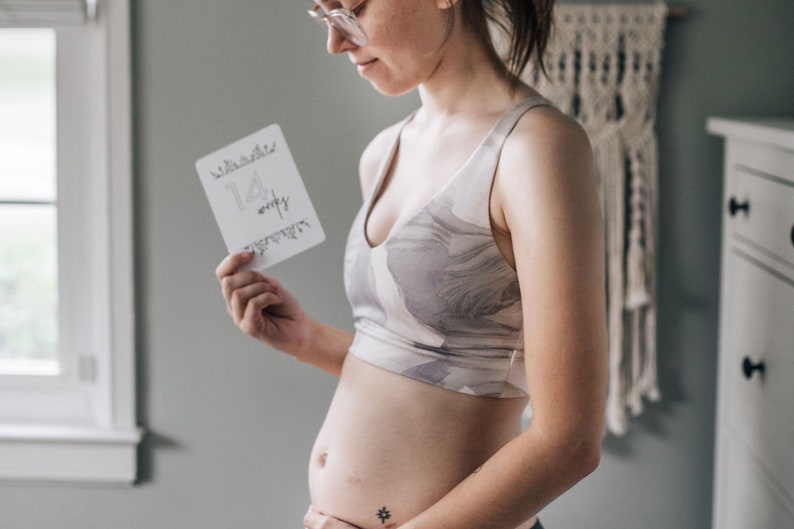 "14 Weeks" Minimalist Pregnancy Milestone Card being held by pregnant woman next to her growing belly -  by Nuts & Bolts Paper Co