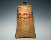 Hand woven pocket basket with peach accents