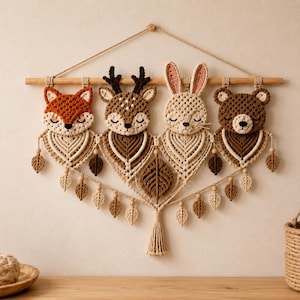 May include: A macrame wall hanging featuring four crocheted animal heads: a fox, a deer, a rabbit, and a bear. Each animal is suspended from a wooden dowel with a rope hanger. The design includes intricate macrame leaf patterns and a central tassel.