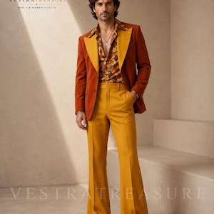 May include: A rust-coloured blazer with wide mustard yellow lapels, a mustard yellow button-down shirt with a brown and orange floral pattern, and matching mustard yellow flared trousers. The outfit includes dark brown leather dress shoes.