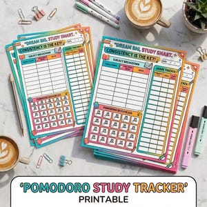 May include: A stack of printed study tracker sheets with a rainbow gradient border. Each sheet features the text "DREAM BIG, STUDY SMART. CONSISTENCY IS THE KEY!" and includes sections for subject breakdown, a grade tracker, and a pomodoro session log.