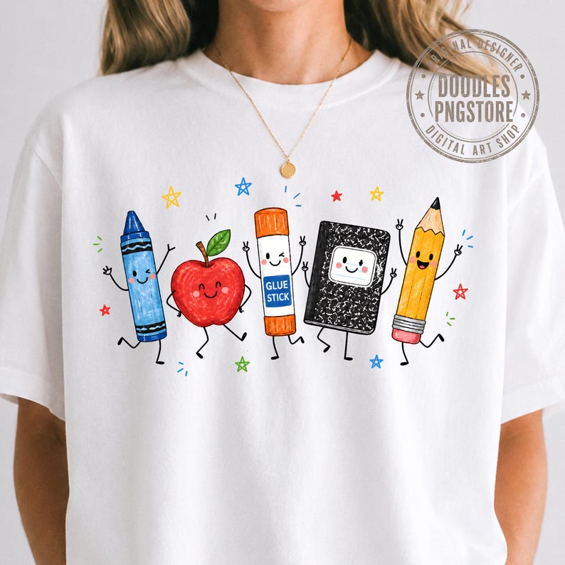 May include: A white t-shirt featuring a colorful graphic of five anthropomorphic school supplies: a blue crayon, a red apple, an orange glue stick labeled GLUE STICK, a black composition notebook, and a yellow pencil, all surrounded by small stars.