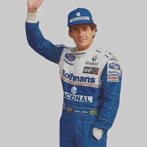 May include: A blue and white racing suit featuring the Rothmans, Renault, Elf, and Nacional logos, paired with a matching blue Nacional baseball cap. The suit includes sponsor patches, a white collar, and the name Ayrton Senna with a Brazilian flag.