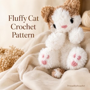 May include: A fluffy, white and tan crocheted cat plush toy with black eyes and pink stitched nose and paw pads. The text Fluffy Cat Crochet Pattern is printed on the left, and the text ThreadByRoseArt is printed in the bottom right corner.