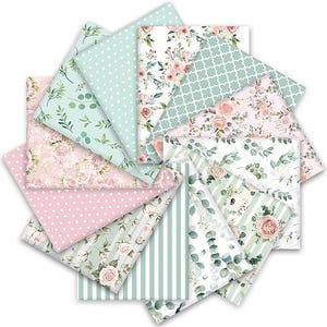 May include: A collection of fabric squares arranged in a circular fan pattern, featuring various prints including light pink and mint green polka dots, vertical stripes, green eucalyptus leaves, and clusters of pink roses on white backgrounds.