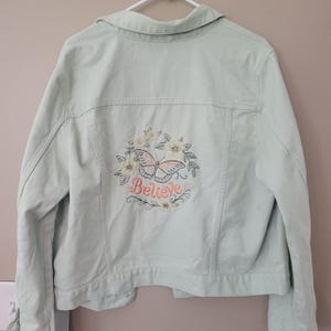 Believe with butterfly and flowers embroidered Upcycled hippie denim jacket. unique one of a kind women&#39;s size XL light green denim jacket