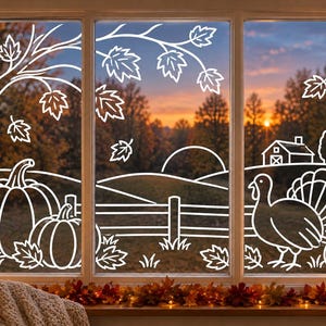 May include: A white line art window decal featuring a fall harvest scene with pumpkins, a turkey, a tree with falling leaves, a wooden fence, and a farmhouse. The design is applied to a three-pane window overlooking a sunset landscape.