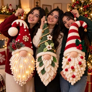 May include: Three handmade crochet gnome wall hangings. The left gnome is red with a snowflake and lights. The center gnome is green with flowers and gold bells. The right gnome has red and white stripes, holly leaves, and red pom-poms.