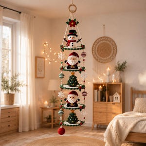 May include: A vertical hanging mobile featuring five stacked circular tiers decorated with crocheted Christmas figures including a snowman, two Santa Clauses, and two Christmas trees, accented with red and green beads and white snowflakes.