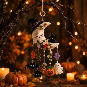 May include: A crocheted crescent moon ornament featuring a black witch hat, a small black cat, and colorful floral accents. Dangling from the moon are crocheted charms including a bat, a spider, a jack-o'-lantern, and a ghost, all on strings.