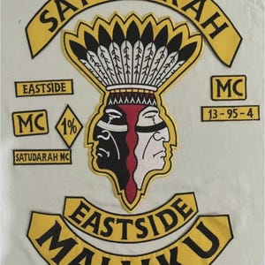 May include: A set of embroidered patches featuring the text SATUDARAH, EASTSIDE, MC, 13-95-4, and MALUKU. The central emblem depicts a dual-faced figure in black and white with a red center, wearing a large feathered headdress in yellow and black.