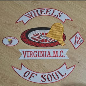 May include: A set of embroidered patches featuring a white banner with the text WHEELS in red, a central circular patch with a red wheel and gold wing, a white banner with VIRGINIA.M.C. in red, a diamond patch with 1%ER, and a banner with OF SOUL.