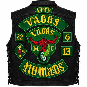 May include: A black denim vest featuring large embroidered patches in green and yellow. The back displays the text VFFV, Vagos, and Nomads, along with a central red devil graphic riding a motorcycle wheel, the numbers 22, 6, 13, and a 1% diamond patch.