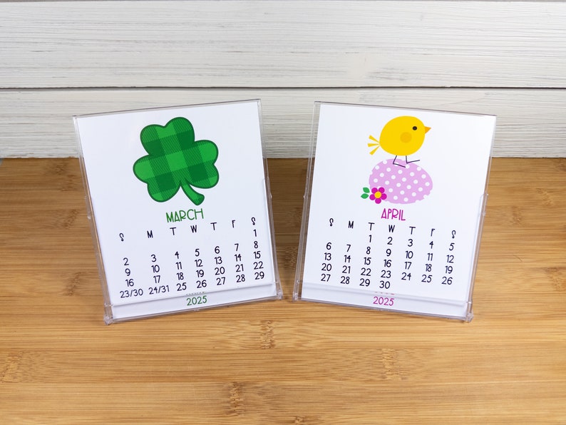 May include: Two small desktop calendars with a green shamrock and a yellow chick design. The March calendar has the dates 1-31 and the April calendar has the dates 1-30. Both calendars are for the year 2025.