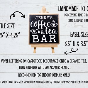 May include: A black chalkboard sign with white lettering that reads "Jenny's coffee & tea bar". The sign is on a small wooden easel and is 4.25 inches by 4.25 inches. The easel is 6.5 inches high and 3.5 inches wide.
