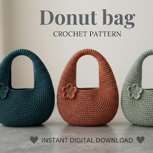 May include: Three donut-shaped crochet bags in dark teal, terracotta, and sage green, each featuring a small crocheted flower accent. The text reads Donut bag CROCHET PATTERN and INSTANT DIGITAL DOWNLOAD. The bags have a rounded handle and base.