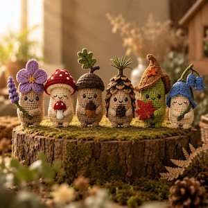 May include: Six small, handcrafted crochet figures featuring nature-inspired designs. The collection includes a purple flower, a red-and-white mushroom, an acorn with a leaf, a pinecone, a green creature with a leaf, and a blue bell-shaped flower.