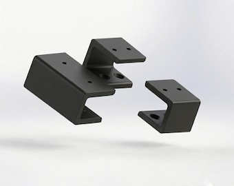 May include: A set of three black C-shaped modular desk mounts with pre-drilled screw holes. The text Layer3dShopUA appears in the top left corner, and the text MODULAR DESK MOUNT KIT 3D-PRINTABLE STL FILES appears in the bottom right corner.
