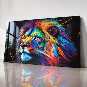 May include: A rectangular wall art piece featuring a vibrant, multi-colored lion portrait against a deep black background. The lion's mane and face are rendered in bold strokes of blue, red, yellow, and purple, with paint splatter effects.