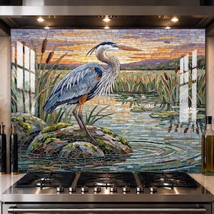 May include: A kitchen splashback panel featuring a mosaic-style illustration of a blue heron standing on a mossy rock in a pond. The scene includes bulrushes, water lilies, and a sunset sky with orange, purple, and blue tiles set against a stove.