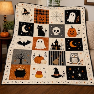 May include: A quilted throw blanket featuring a grid of Halloween-themed squares. Designs include ghosts, jack-o'-lanterns, a black cat, a skull, a spider web, a bat, a haunted house, a crescent moon, a tree, an owl, a cauldron, candy corn, and a witch hat.