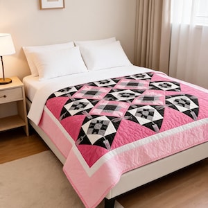 May include: A quilt featuring a geometric pattern of pink, black, white, and gray fabric blocks. The design includes star-shaped motifs and dragonfly appliques arranged in a grid, finished with a solid pink border and white trim on a bed.