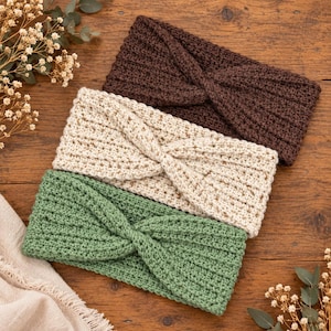 May include: Three crocheted headbands featuring a twisted front design. The set includes one dark brown, one cream, and one sage green headband, each crafted with a textured ribbed stitch pattern that runs horizontally across the entire length.