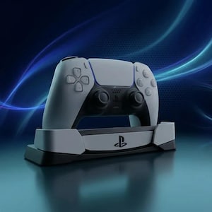 May include: A white and black wireless game controller docked in a matching white and black charging station. The controller features a central touchpad, dual analog sticks, and a directional pad. The PlayStation logo is visible on the charging base.