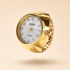 May include: A gold-toned ring watch featuring a round face with a white dial, black Arabic numerals, and the text BOZHI and QUARTZ printed on the face. The band is constructed from flexible, expandable gold-toned metal links for a comfortable fit.