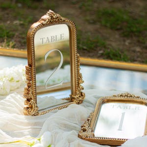 Our Mirror Wedding Table Numbers bring timeless elegance to any celebration, serving as both functional Wedding Table Numbers and eye-catching Wedding Table Decor. Paired with warm Gold Reception Decor accents and a coordinating Wed Sign, these Mirrored Table Numbers Unique pieces create a polished, romantic atmosphere guests will remember.