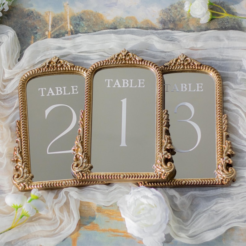 Our Mirror Wedding Table Numbers bring timeless elegance to any celebration, serving as both functional Wedding Table Numbers and eye-catching Wedding Table Decor. Paired with warm Gold Reception Decor accents and a coordinating Wed Sign, these Mirrored Table Numbers Unique pieces create a polished, romantic atmosphere guests will remember.