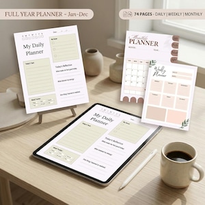 May include: A digital tablet displaying a daily planner template alongside printed sheets for daily, weekly, and monthly planning. The pages feature sections for goals, tasks, reflections, and mood tracking, with text labels including My Daily Planner, Monthly Planner, and Weekly Planner.