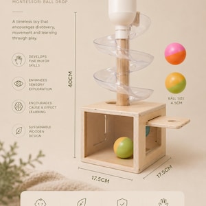 Peut inclure: Un jouet de type Montessori Zenaura avec une base cubique en bois, un poteau central en bois et une piste en spirale transparente surmontée d'un entonnoir blanc. Le jouet mesure 40cm de haut, avec une base de 17,5cm et des balles de 4,5cm.