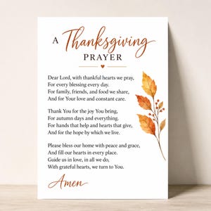 May include: A white rectangular card featuring the text A Thanksgiving Prayer in brown script and block lettering. The prayer includes verses about blessings, family, and gratitude. A watercolor illustration of orange and yellow autumn leaves.