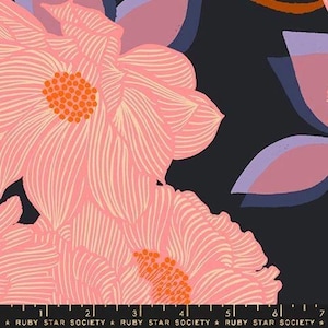 May include: A black fabric featuring large, stylized pink flowers with orange centers and white line details. A purple floral element is visible on the right. A black ruler with white markings and the text RUBY STAR SOCIETY is at the bottom edge.