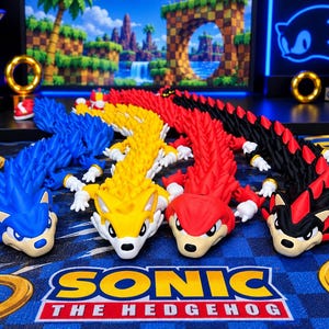 May include: Four articulated, segmented figures inspired by Sonic the Hedgehog characters, arranged in a row. The figures are blue, yellow, red, and black with red accents, each featuring white gloved hands and a stylized head design.