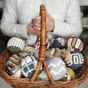 Christmas crochet baubles in a brown basket.