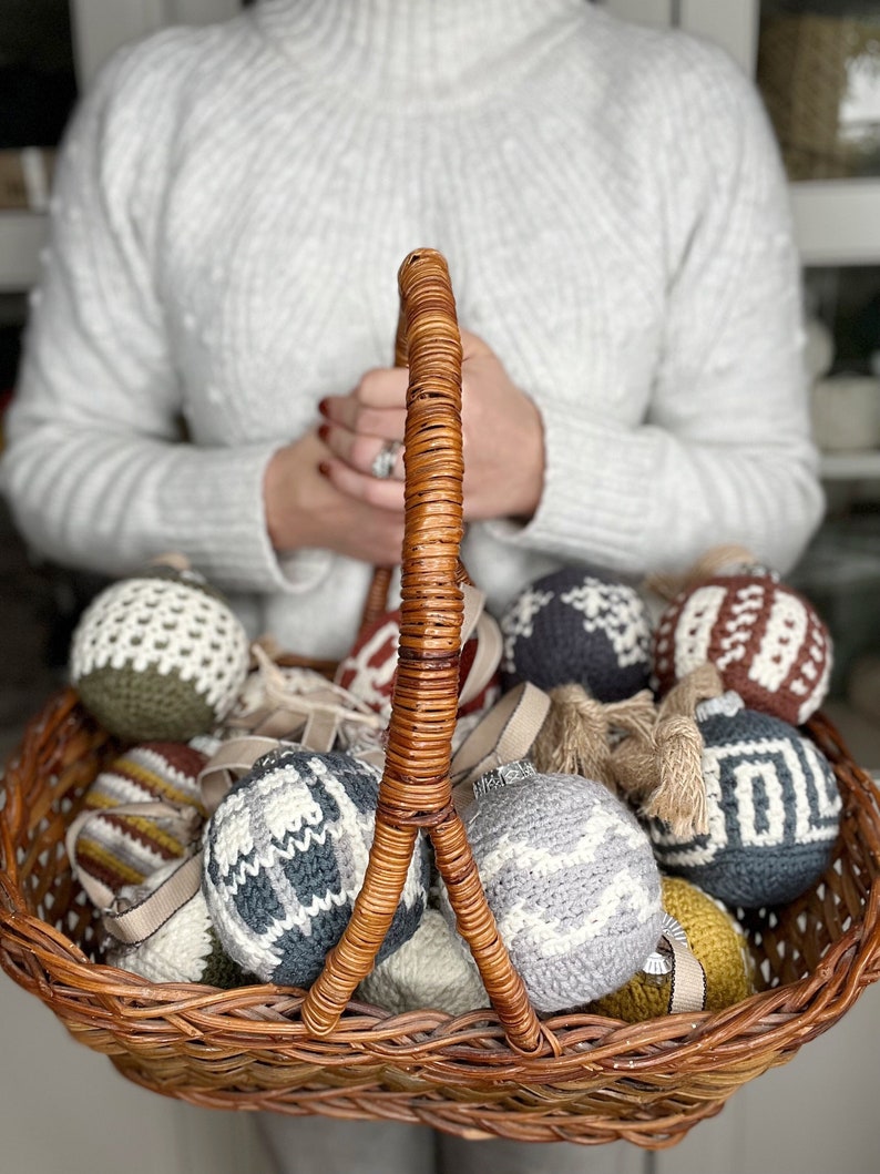 Christmas crochet baubles in a brown basket.