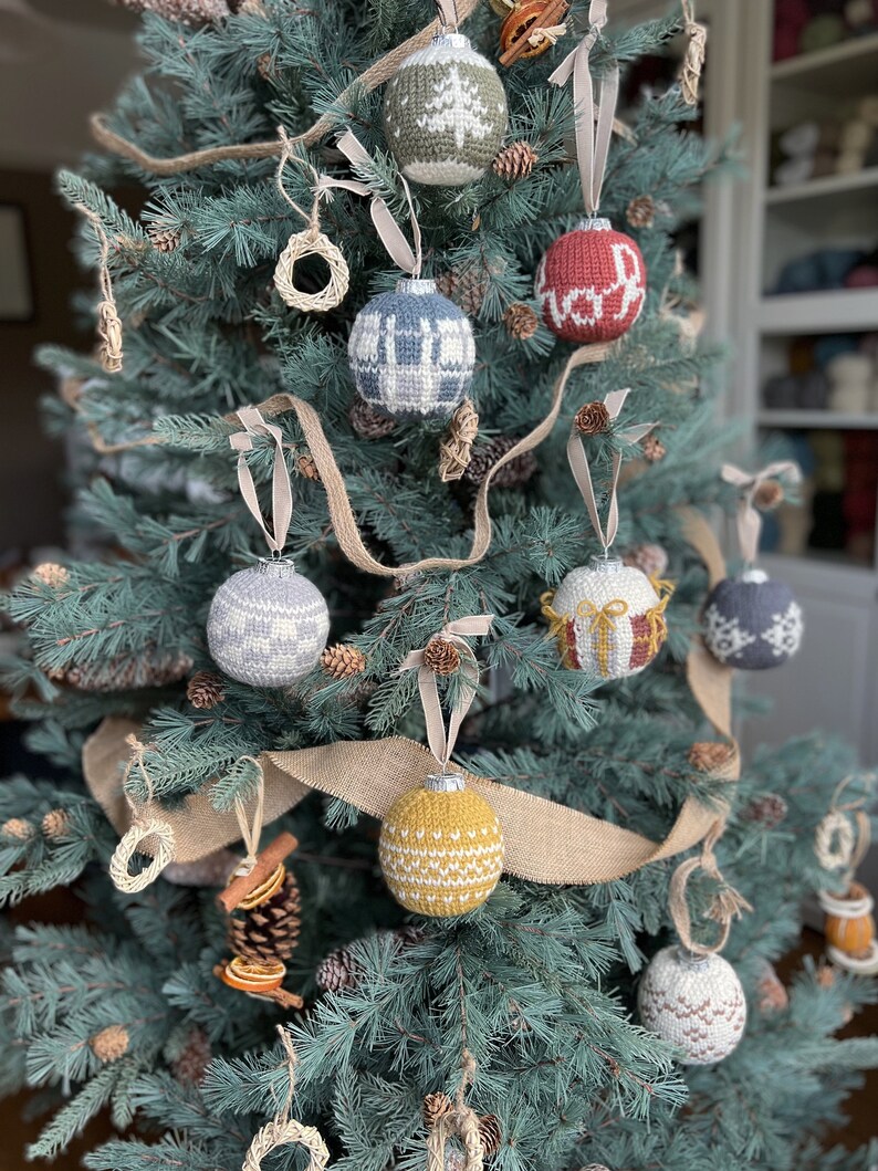 A collection of crochet Christmas baubles on a fir christmas tree.