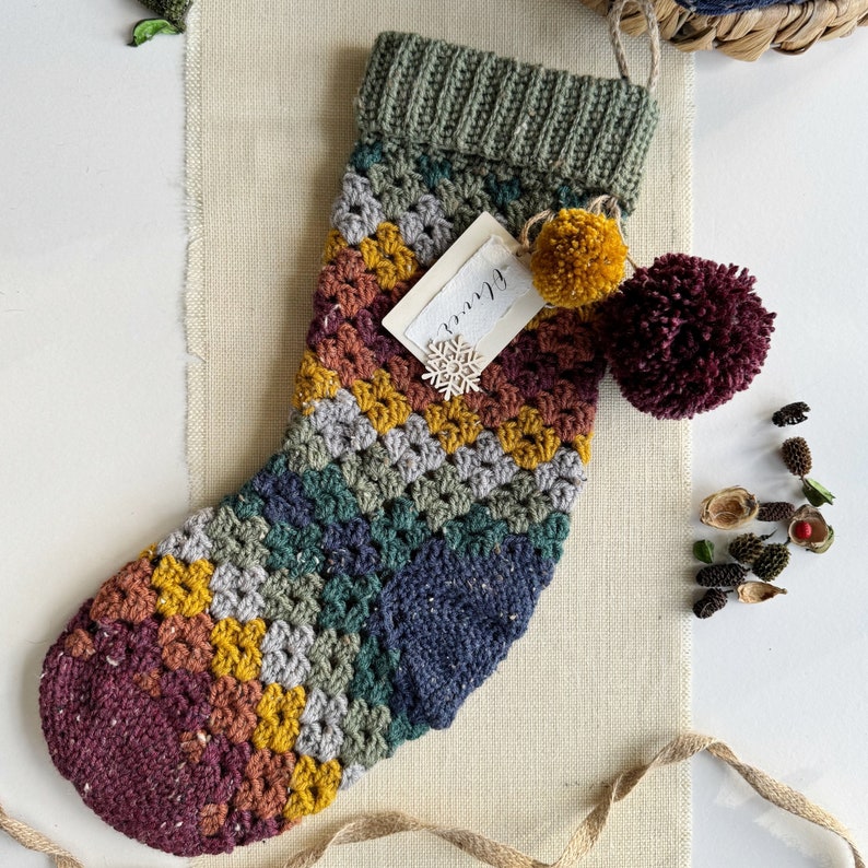 A crocheted Christmas stocking that is multicoloured.