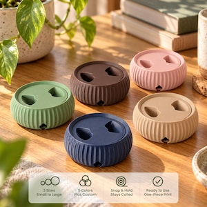 May include: Five round, ribbed cable organizers in sage green, dark brown, light pink, navy blue, and beige. Each features a central lid with two cutouts and a small side notch for cord management. Text at the bottom reads: 3 Sizes Small to Large, 5 Colors Plus Custom, Snap & Hold Stays Coiled, Ready to Use One-Piece Print.