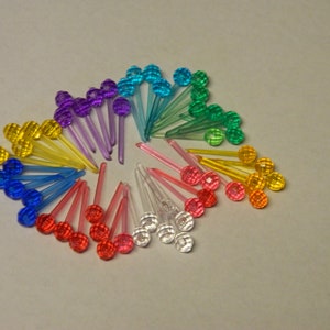 May include: A collection of colorful Christmas light bulbs with a variety of colors including red, yellow, blue, green, and purple.