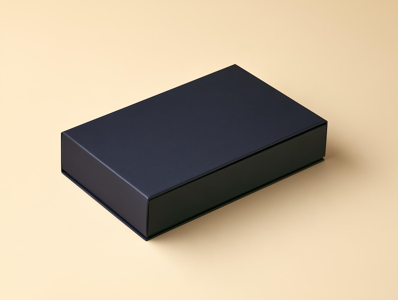 AI-assisted studio design visual of a closed navy drawer-style matchbox on an ivory background. Illustrates the broad 14.5 x 10.5 x 3.5 cm outside box format; final artwork and colours are agreed in your proof.