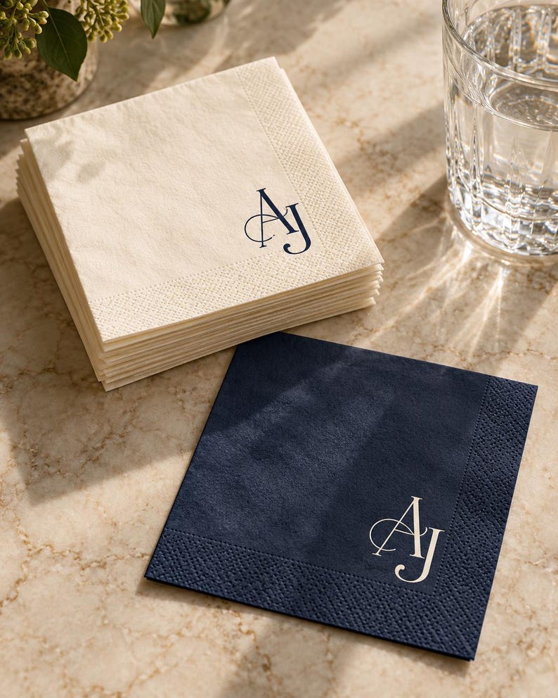 Cream and navy cocktail napkins with an AJ monogram