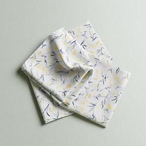 Square cocktail-napkin and paper-detail mockups with fine botanical line illustrations, styled with coordinating paper pieces. Digital presentation of a custom illustrated wedding and event design.
