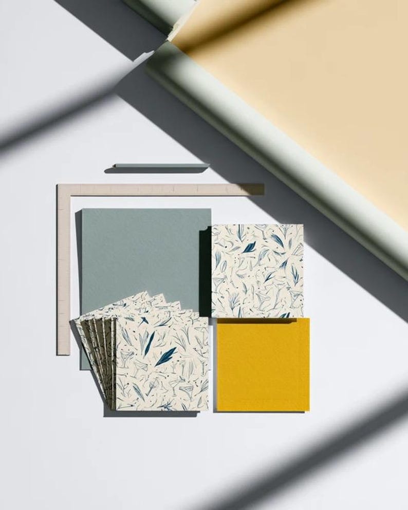 Square cocktail-napkin and paper-detail mockups with fine botanical line illustrations, styled with coordinating paper pieces. Digital presentation of a custom illustrated wedding and event design.
